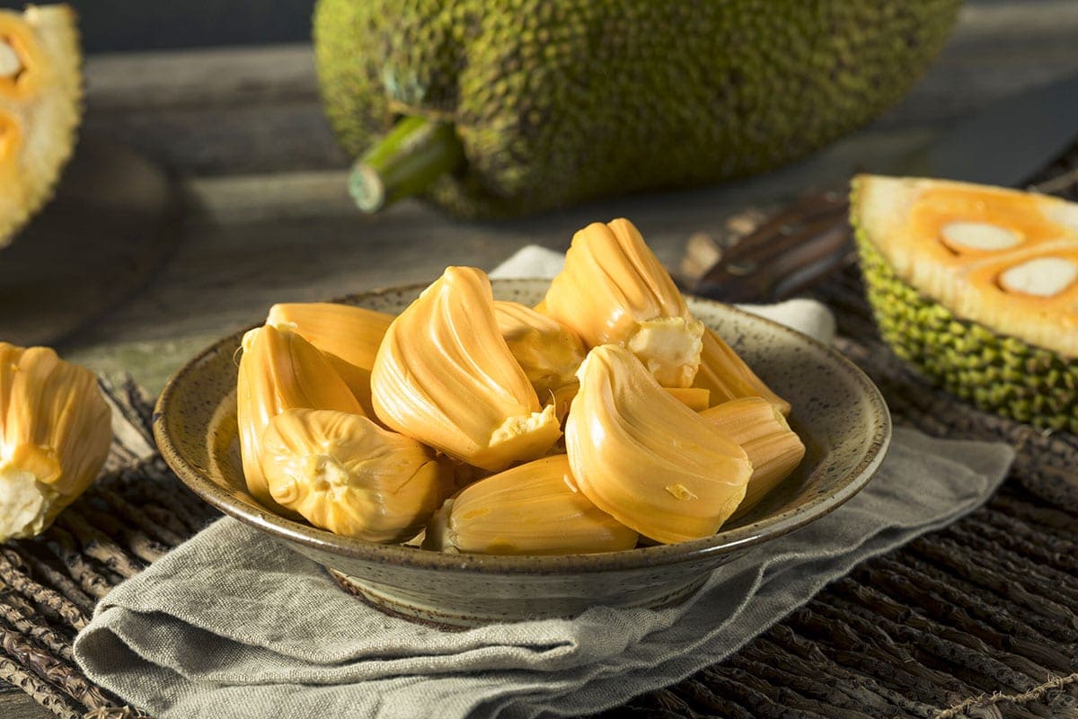 ripe jackfruit on a plate on a green background