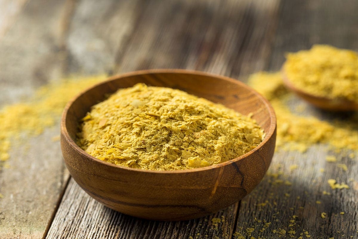 fortified nutritional yeast flakes in a wooden bowl