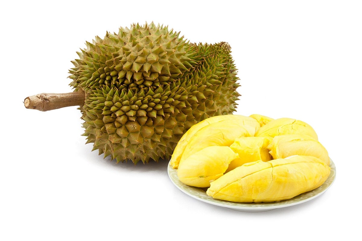Durian fruit whole and shelled isolated on a white background