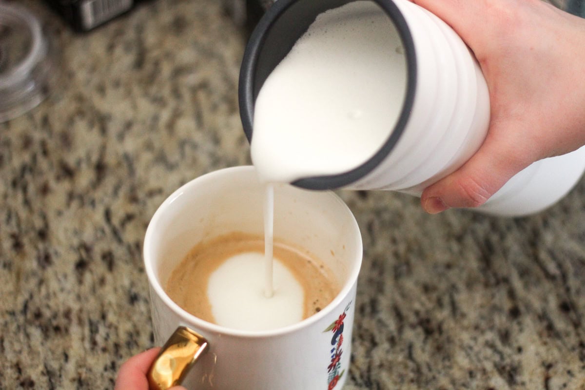 frothing oatly oat milk in the miroco milk frother for the dirty chai latte
