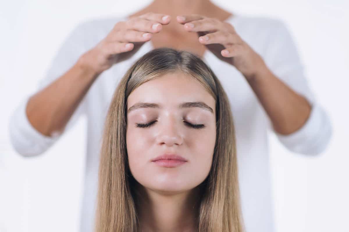 woman receiving energy work on crown chakra