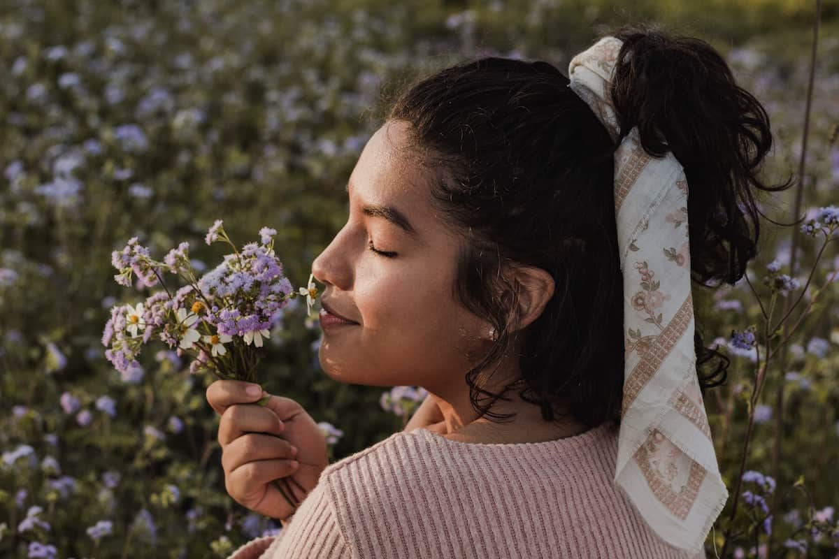 woman smelling flowers