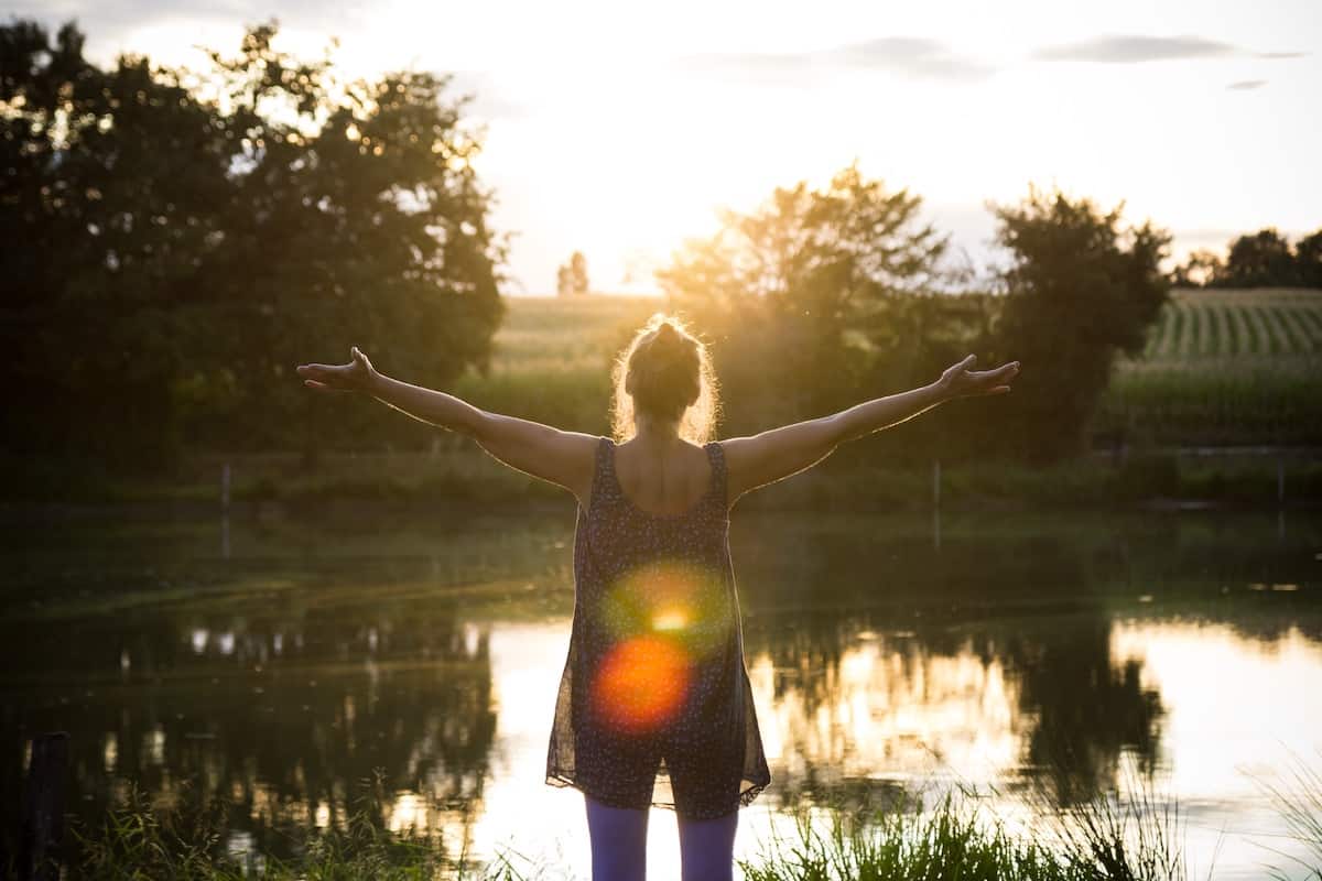 woman opening arms wide in receiving posture