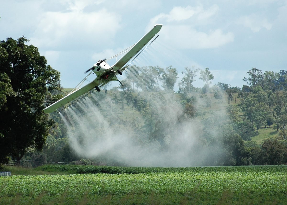 A crop duster dusting crops