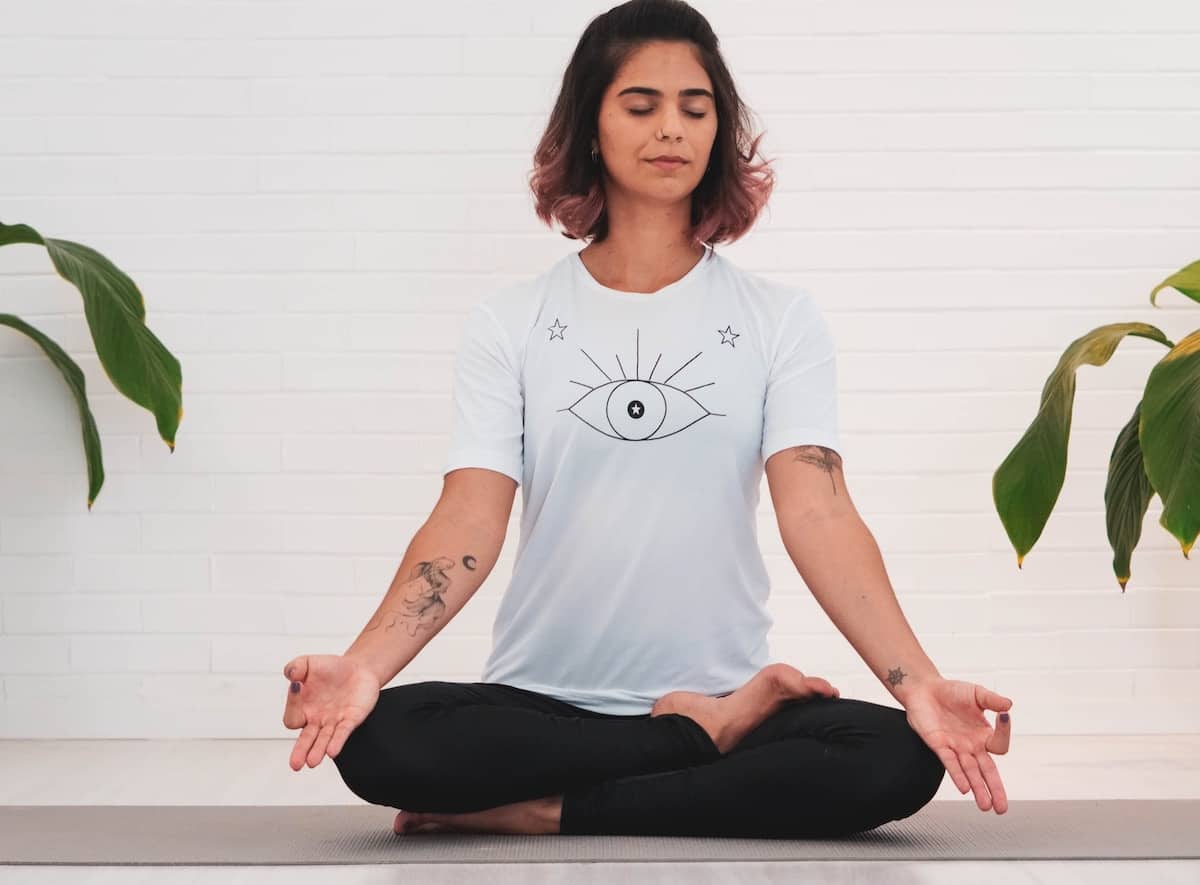 woman sat in meditation posture preparing for pranayama