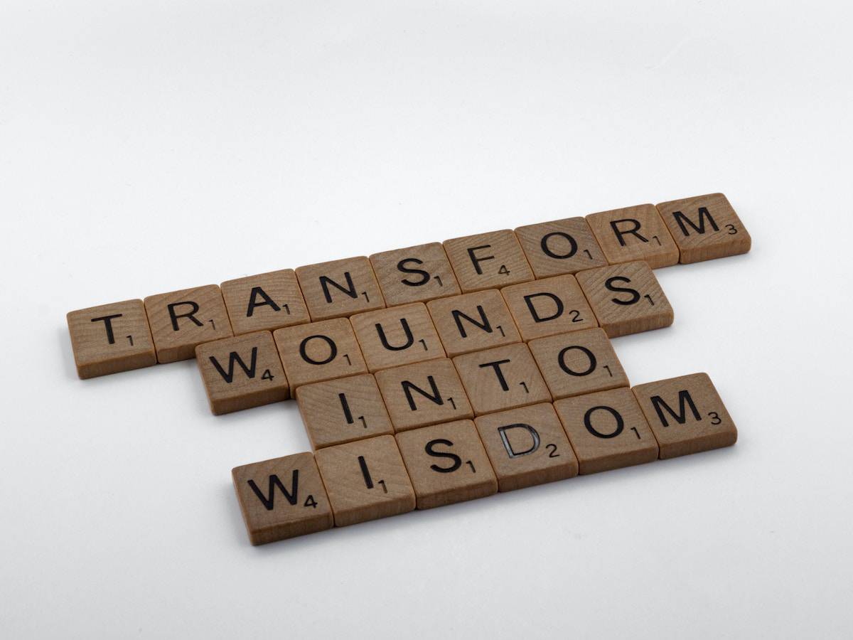 letters that read "transform wounds into wisdom"