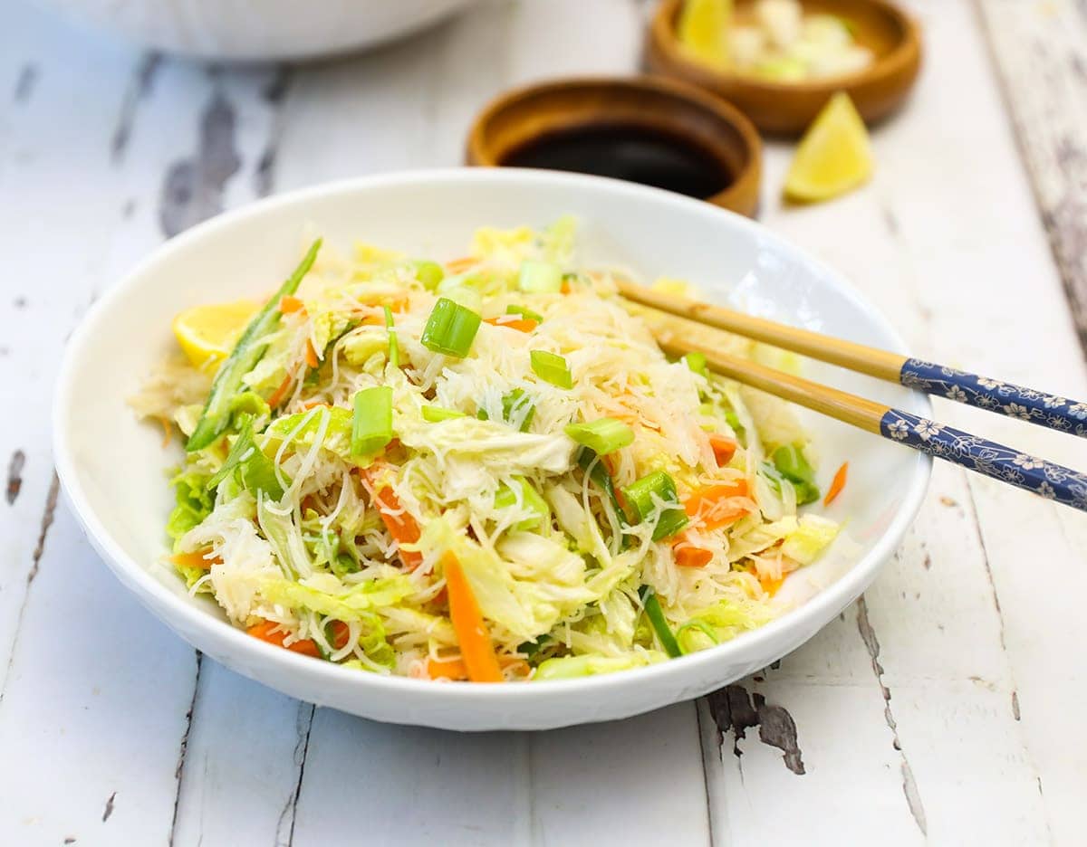 napa cabbage salad in white bowl close up
