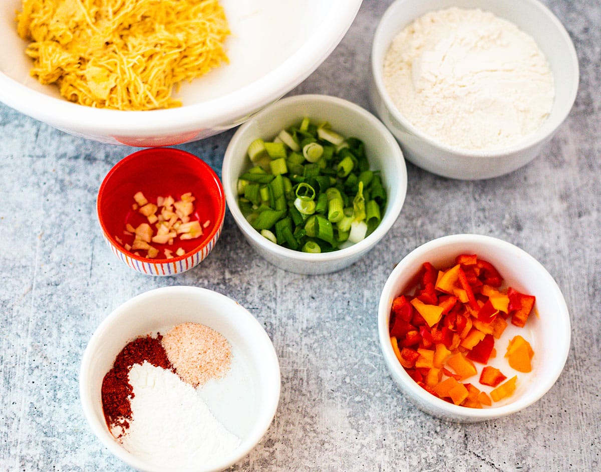 Ingredients for plantain fritters on a grey concrete board