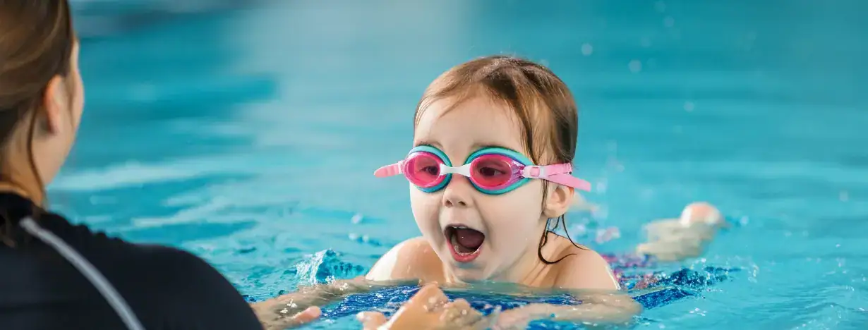 1 to 1 summer swimming crash course instructor giving gentle lesson to a young child in South West London pool