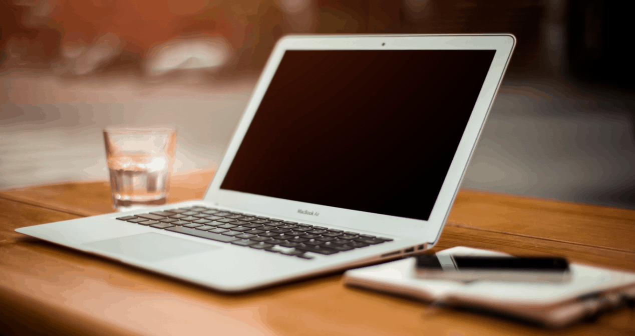 laptop sitting on wooden desk