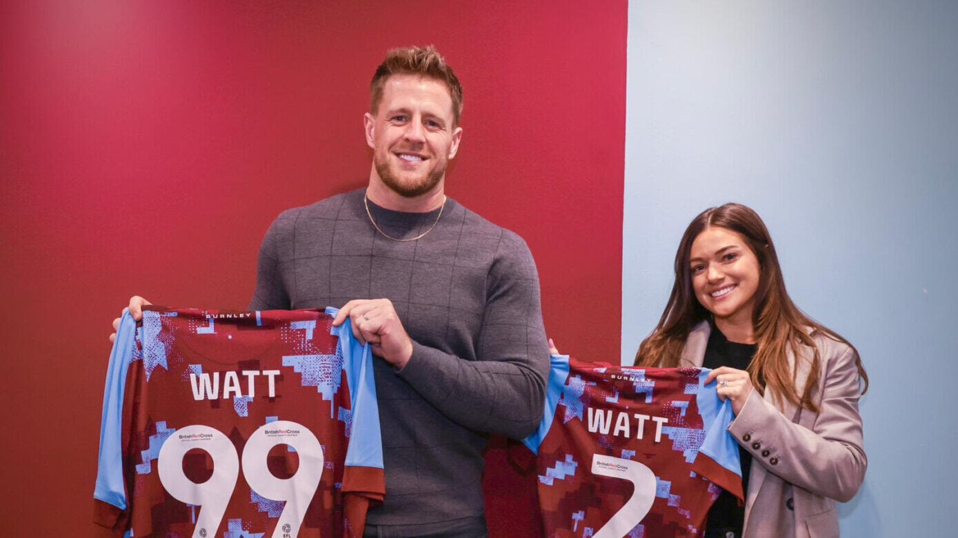 JJ Watt and Kealia Watt holding up Burnley FC soccer jerseys featuring their names