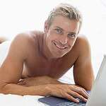 How to Spot Red Flags in Online Dating: Protect Yourself and Find Genuine Connections 9 man lying in bed with laptop smiling SYQgDEjRBj