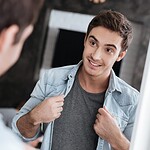 How to Keep Online Dating Conversations Flowing: From First Messages to Meaningful Connections 11 man smiling at himself looking into the mirror scaled