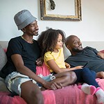 Celebrate Pride Month with These 9 Fabulous Date Night Ideas for the LGBTQIA+ Community 6 a family watching on the living room