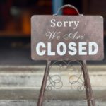 close up of a metal closed sign