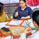 Participant works on a fabric-covered frame during the Frame and Fabric Workshop at Galleria Shopping Mall.