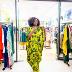 Connie Oluoch stands beneath the Vivo sign at the entrance to the Style, Shop & Sip event.