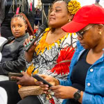 A guest speaks into a microphone during the Style, Shop & Sip event at Galleria Shopping Mall
