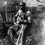 farm worker taking a break to play his guitar