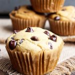 Peanut Butter Muffin with chocolate chip. More muffins and peanut butter on spoon in background