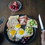 sliced bread with sliced tomato and cucumber on black ceramic plate
