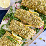 Pistachios crusted salmon on a bed of salad