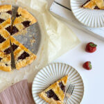 Crostata di marmellata slices on 2 white rimmed plates