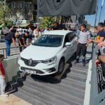 KÜTAHYA'DA SÜRÜCÜSÜNÜN KONTROLÜNDEN ÇIKAN OTOMOBİL, BİR ZİNCİR MARKETİN GİRİŞ MERDİVENLERİNDE ASILI KALDI
