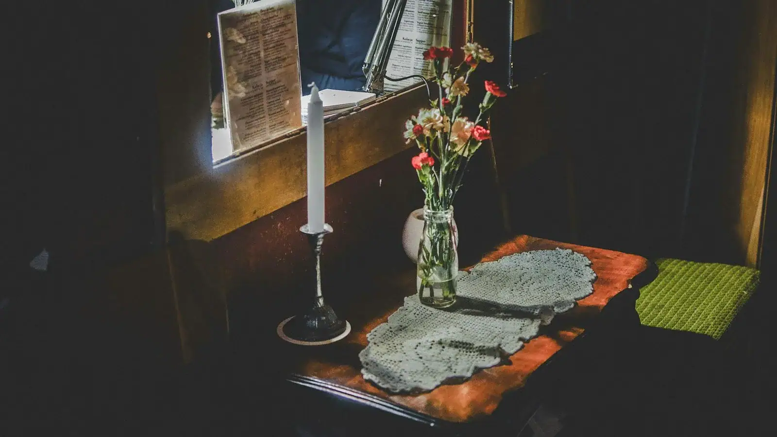 candle stick on top of table with flower vase