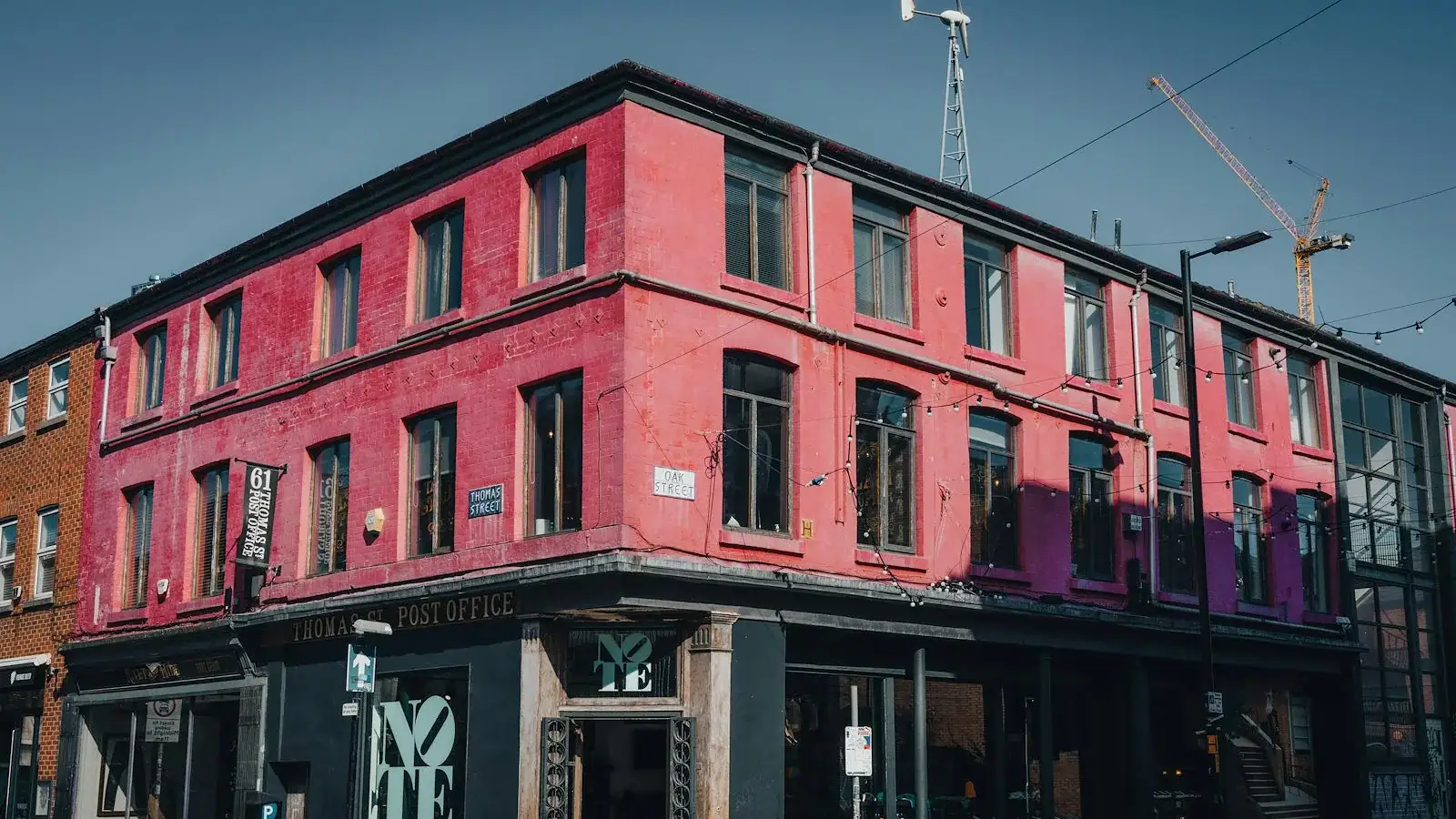 a tall red building sitting on the corner of a street