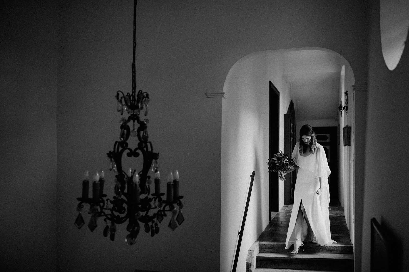 bride walking down stairs of French chateau wedding