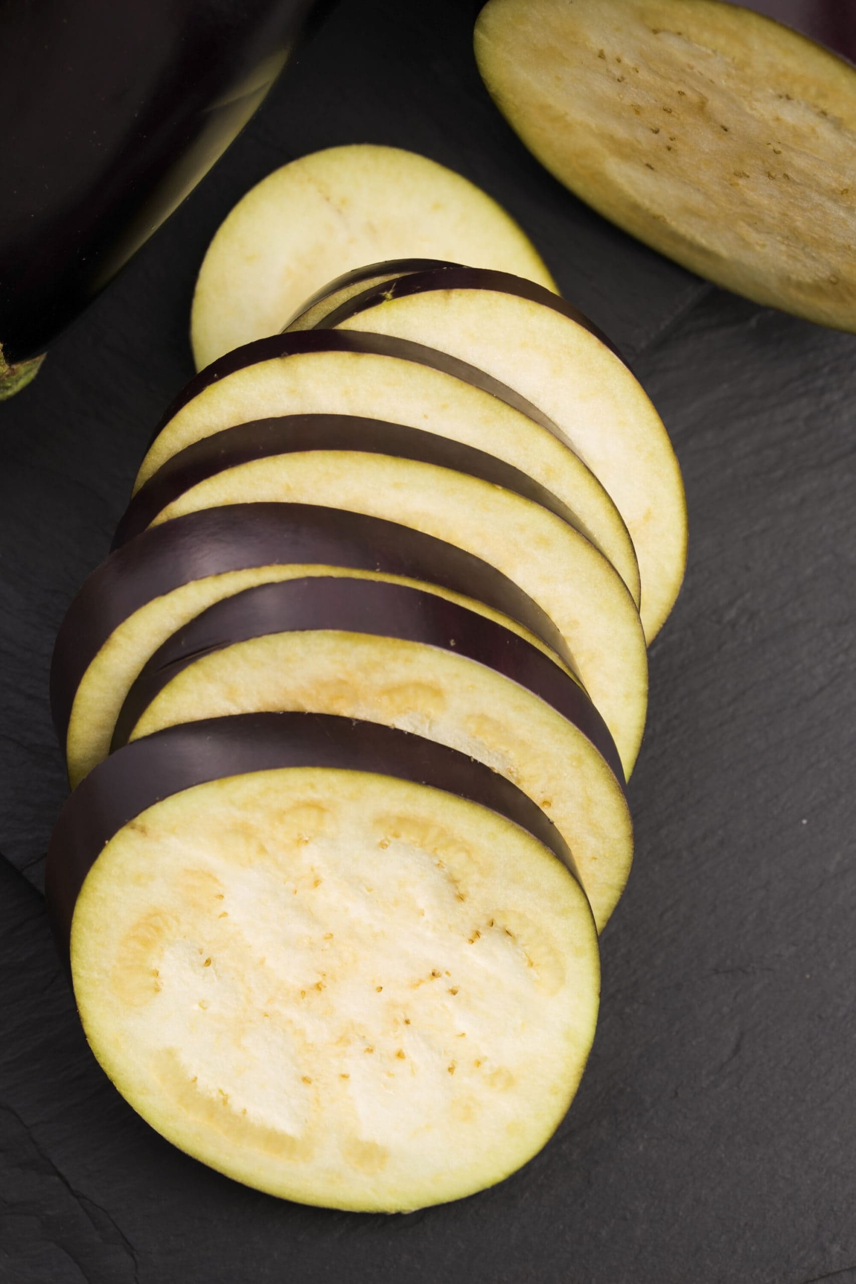 eggplant slices on a dark background