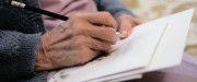 Elderly person addressing a letter