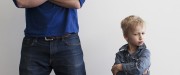 Child folding arms in defiance of his dad