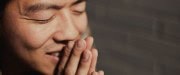 man praying and smiling