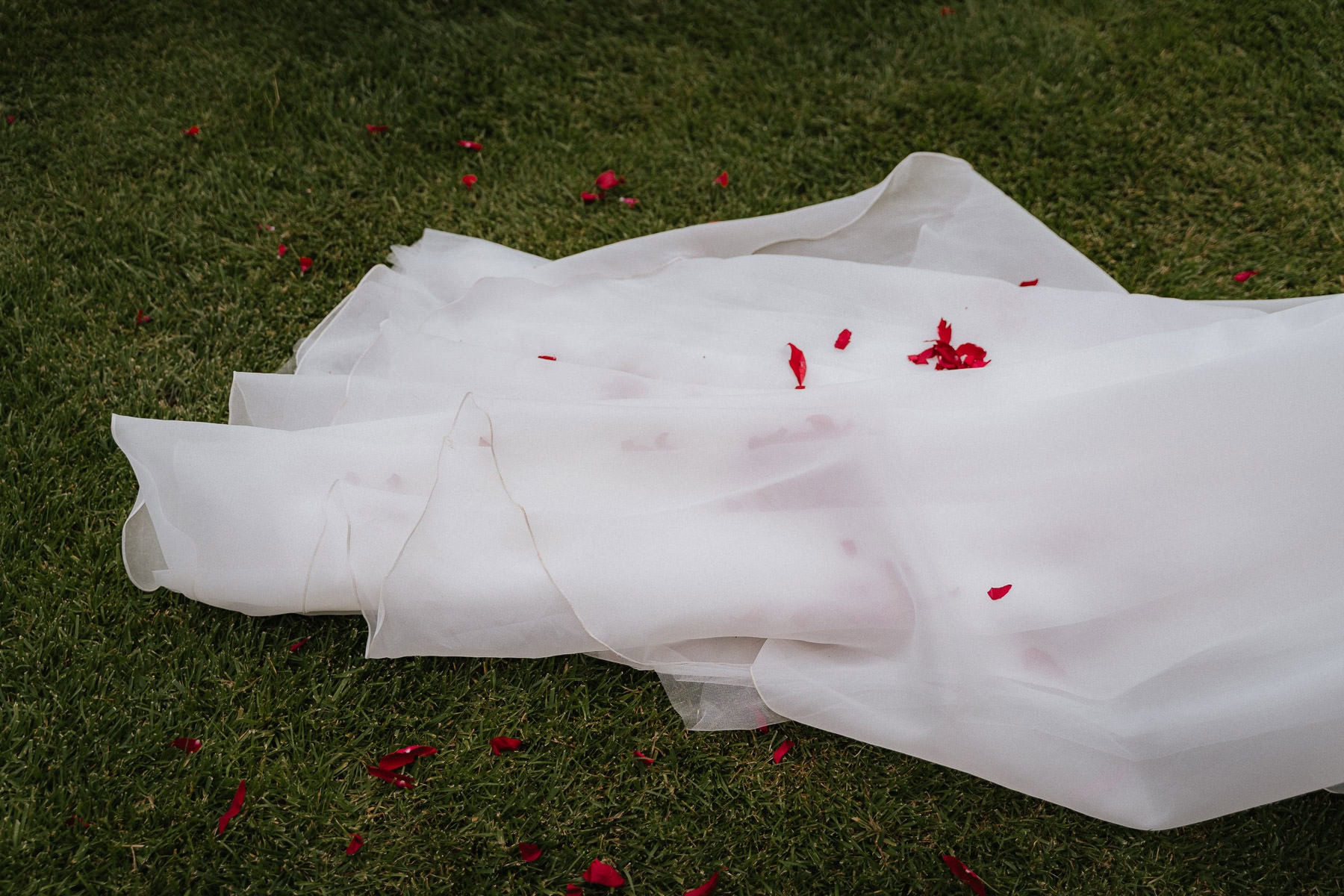 Close-up of rose petals on the bride’s wedding dress at a Finca wedding in Girona