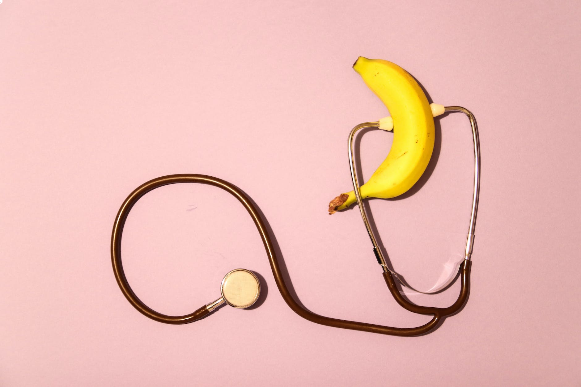 How to Achieve and Sustain Erections That Lasts: A Guide for Men 2 a banana and a stethoscope on a pink surface