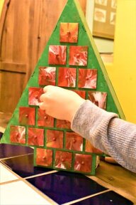 Wooden tree-shaped DIY Advent Calendar with child opening drawer