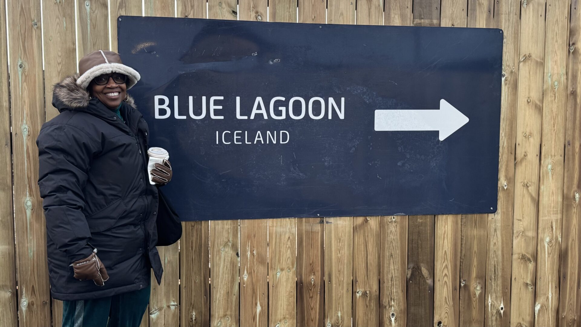 Bernadine Atwell in front of the Blue Lagoon sign in Iceland