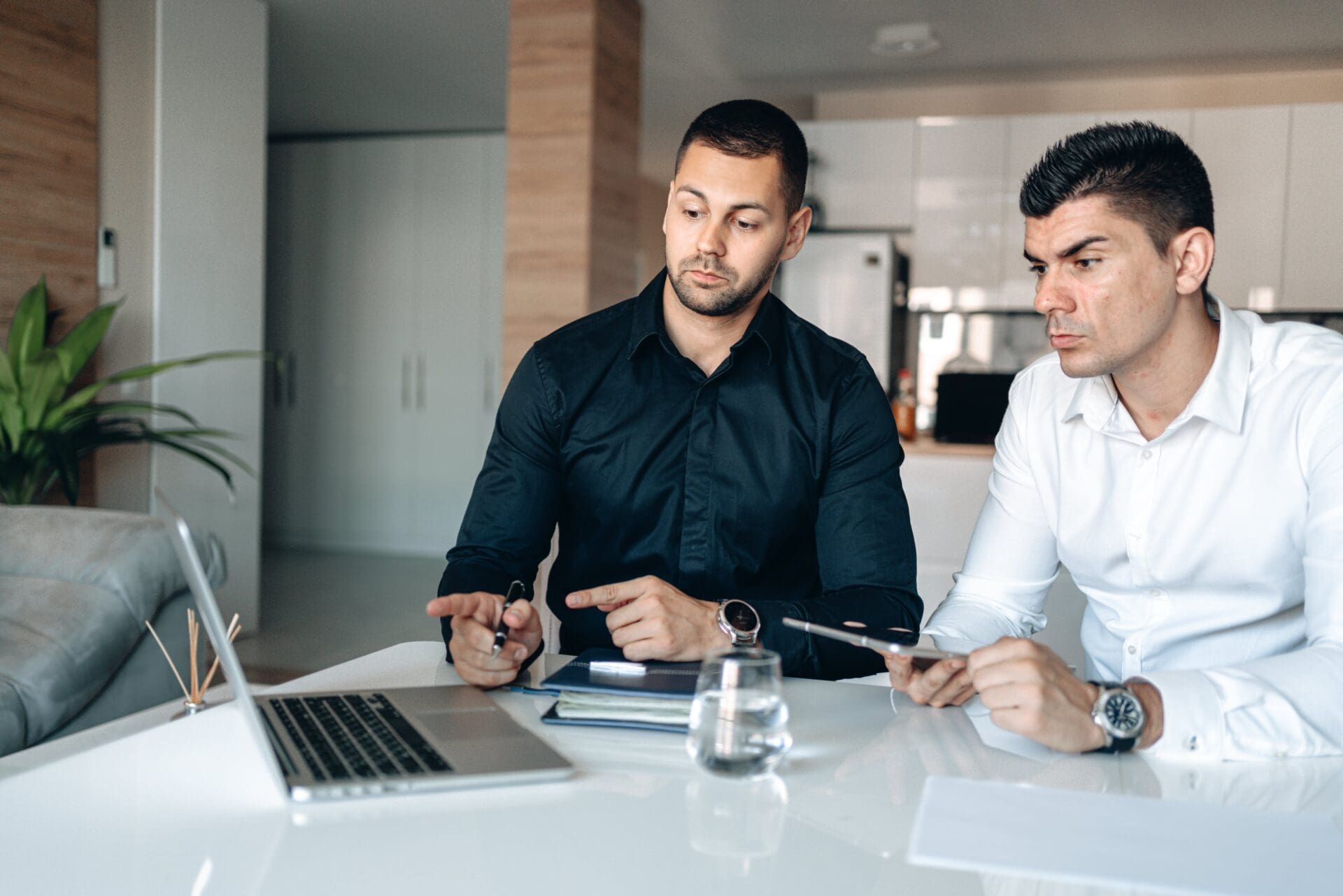 Two partners working through the details of a real estate investment deal.