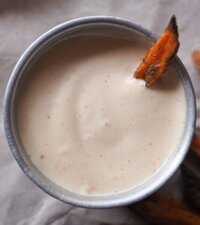 Spicy Mayo Dip with mayo, mustard and cayenne pepper. The dip is in a metallic bowl with a sweet potato dipped in it.