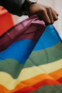 Celebrate Pride Month with These 9 Fabulous Date Night Ideas for the LGBTQIA+ Community 7 unrecognizable african american guy with pride flag during parade