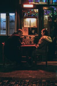 fred mouniguet - couple sitting across from each other