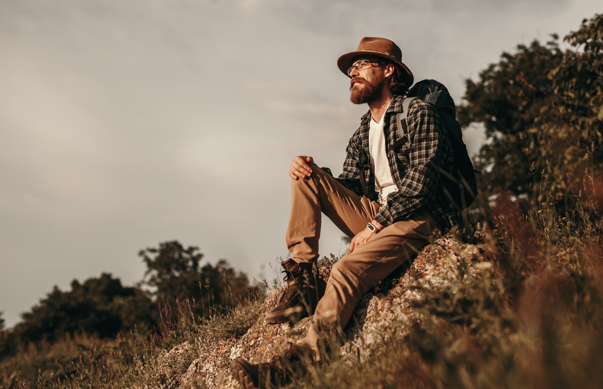 Relaxed thoughtful male traveler enjoying natural landscape