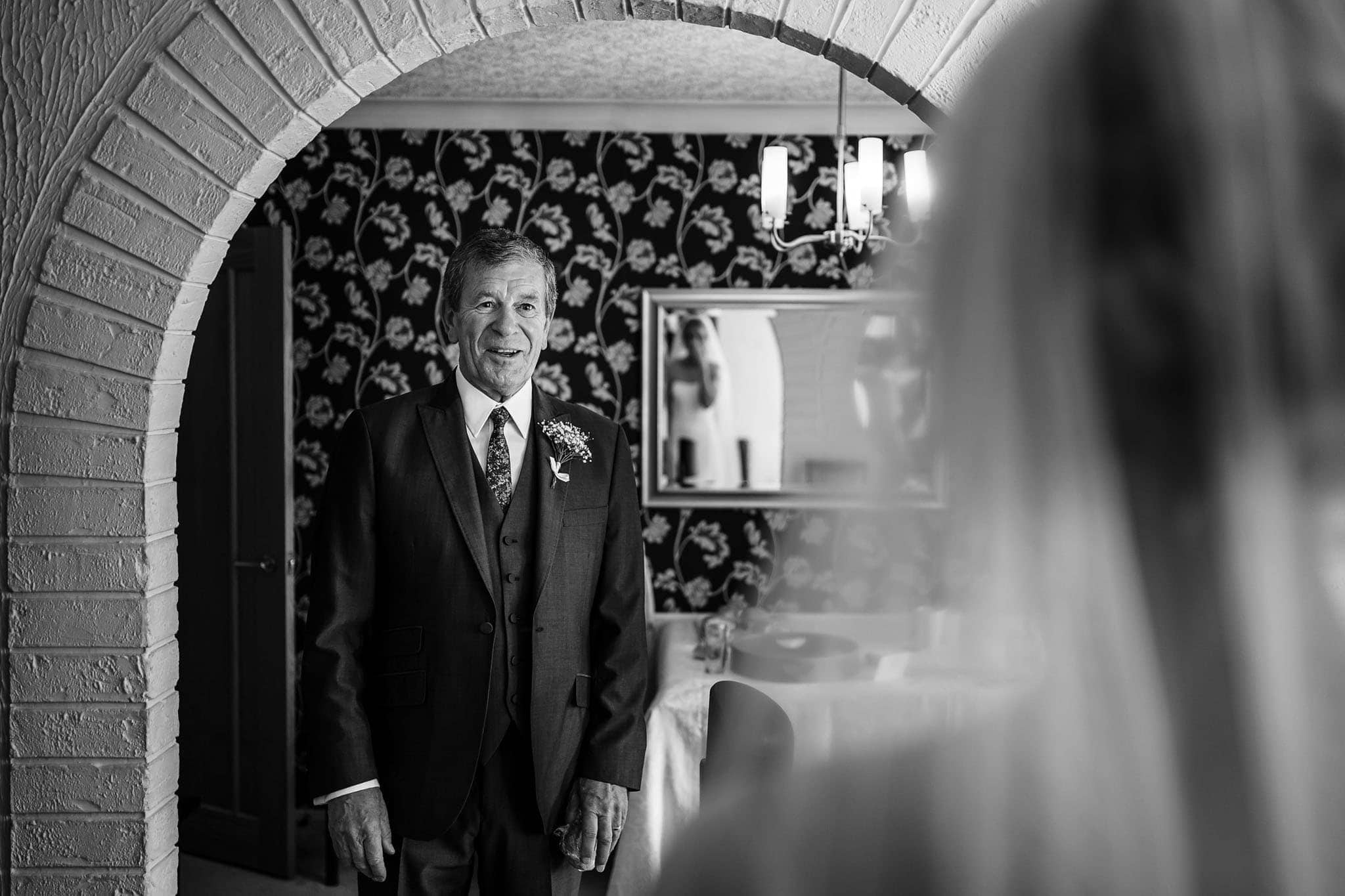 father of the bride seeing his daughter in her dress for the first time
