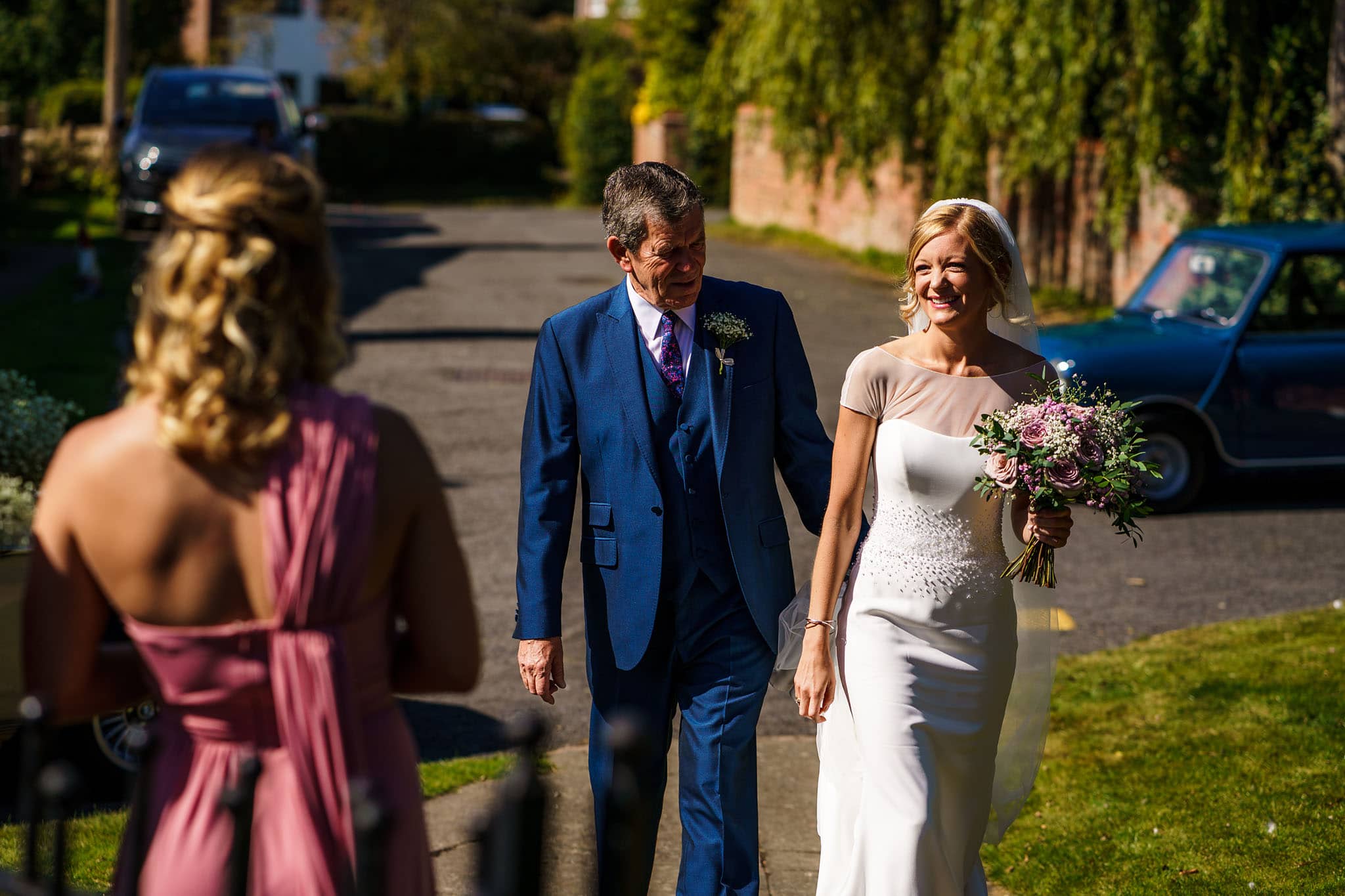 bride and her dad walking up to the church