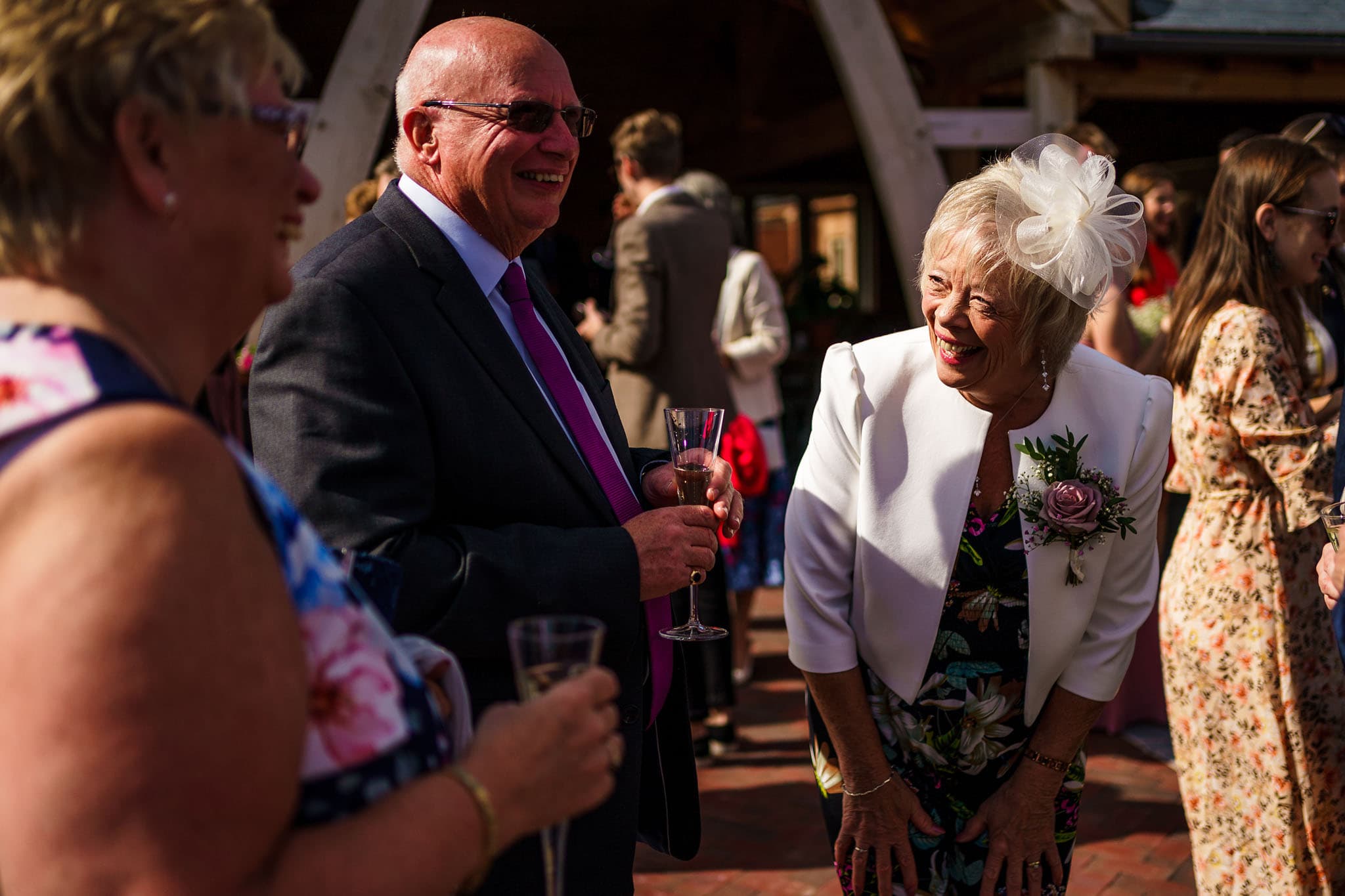 mother of the bride laughing whilst chatting to guests