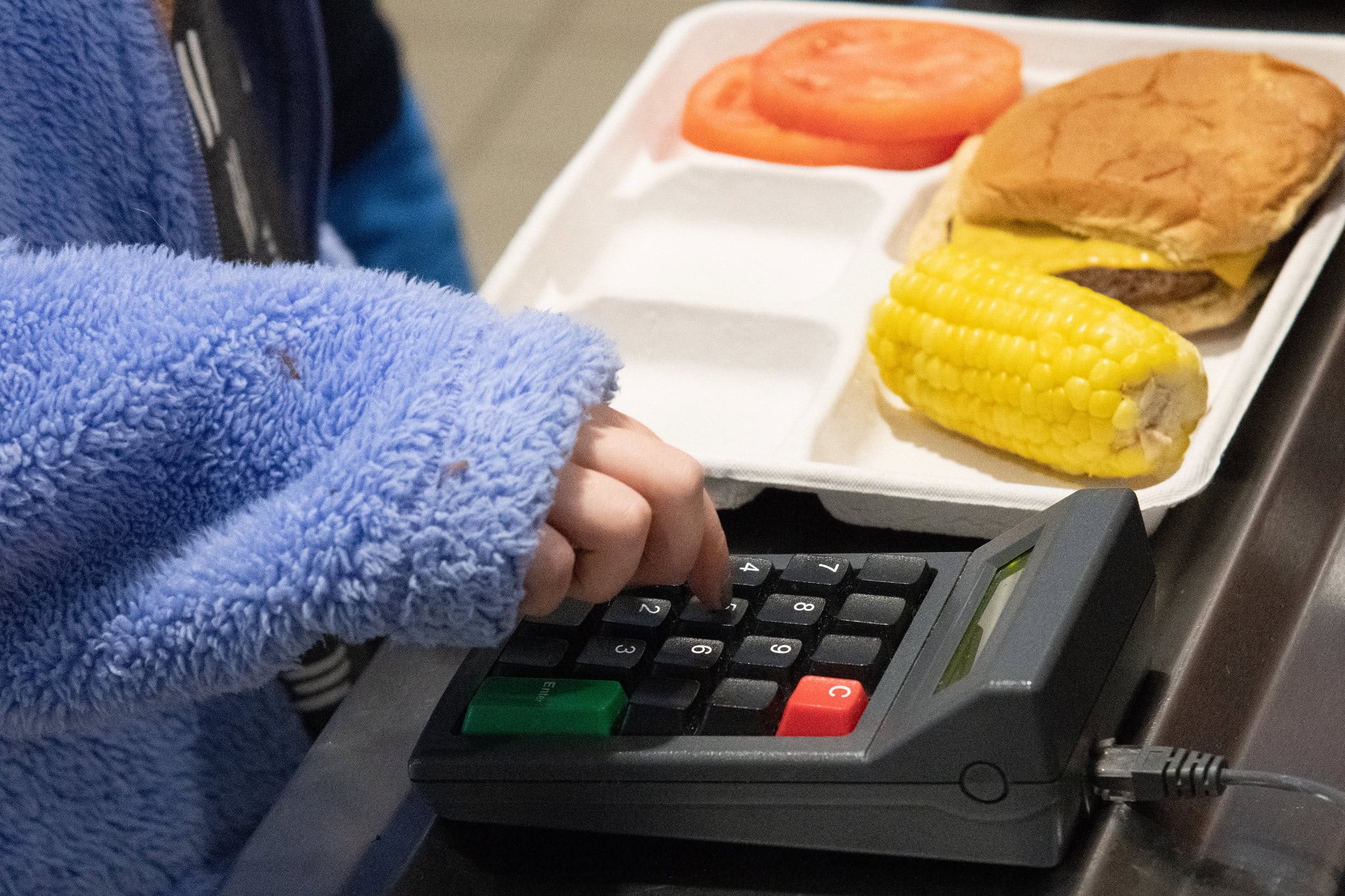 A student types in her lunch number
