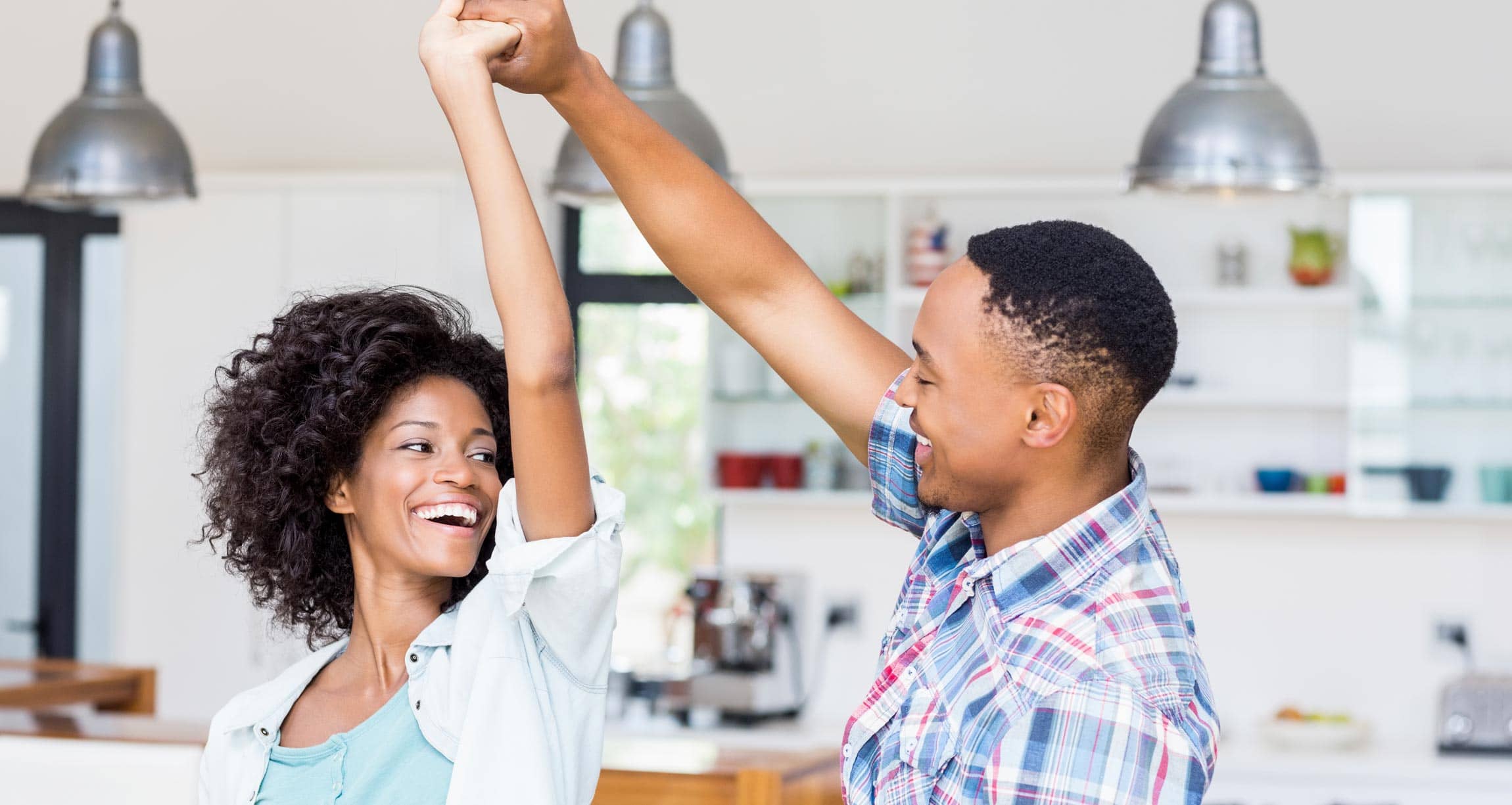 a couple dancing in the kitchen