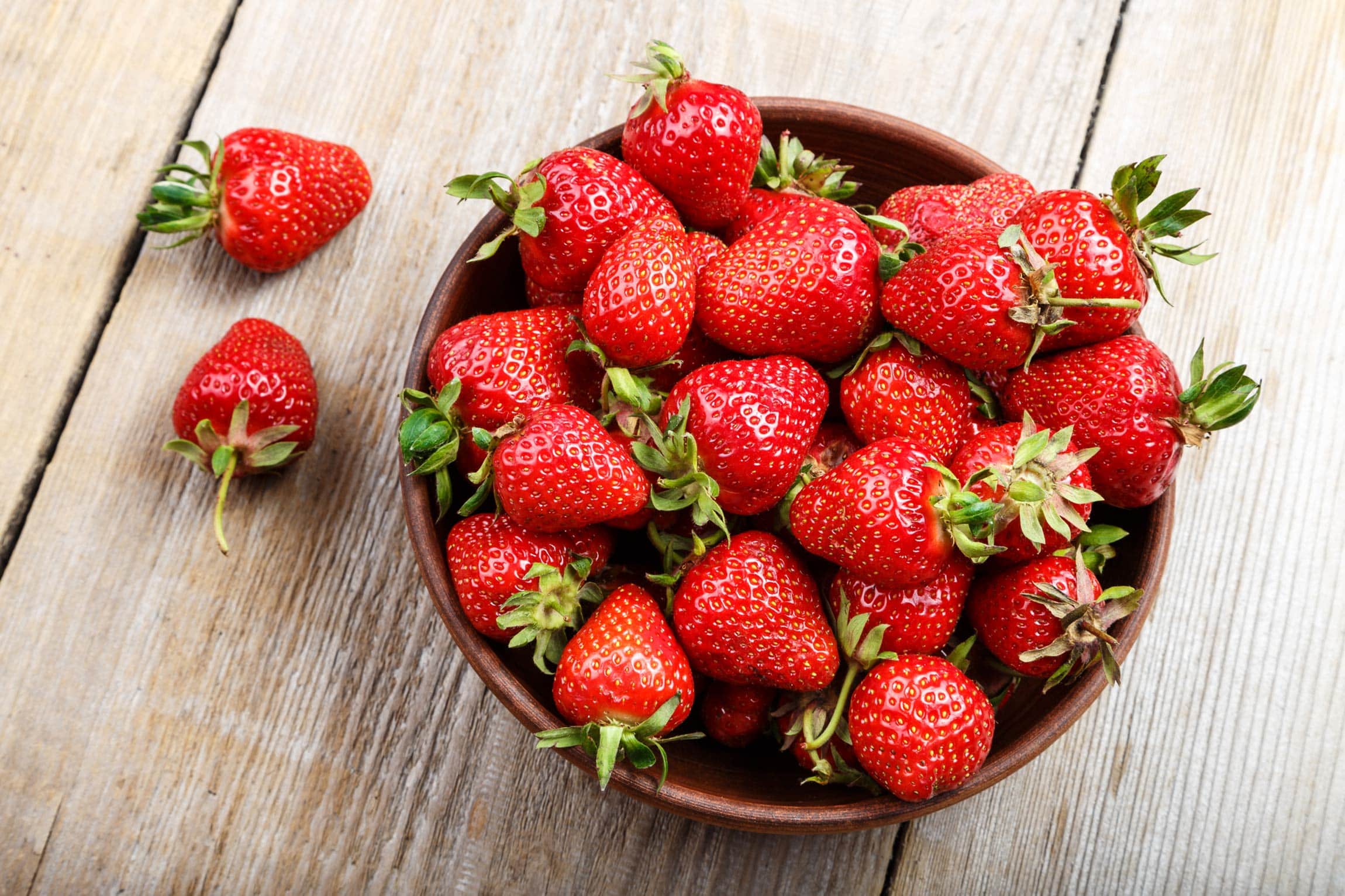 strawberries in a bowl on table